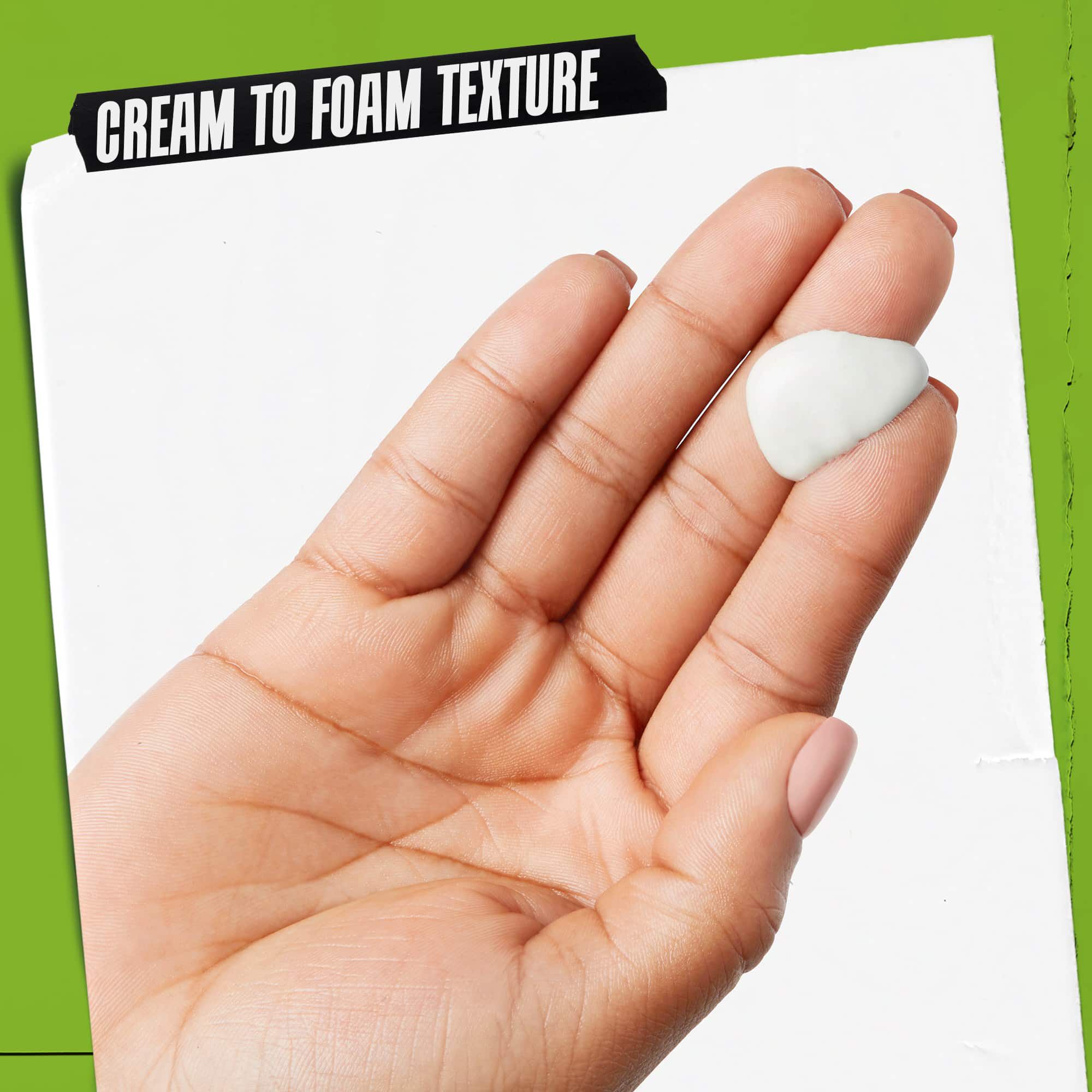 A hand with Rare Earth Deep Pore Daily Cleanser on it. The text emphasizes, "Cream to Foam Texture".