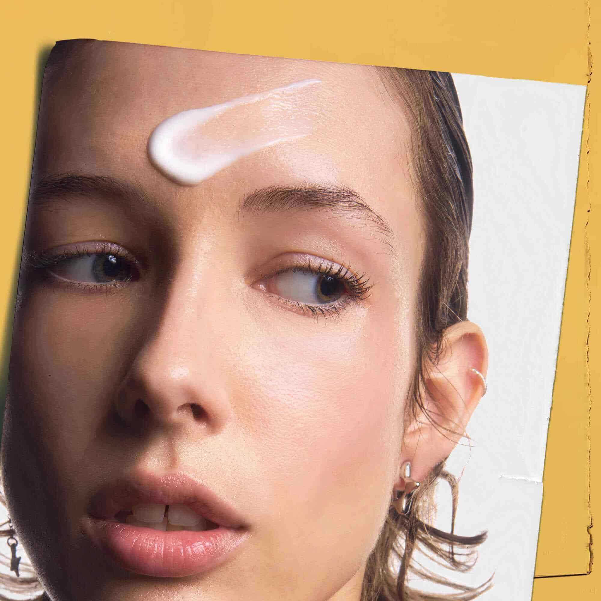Powerful-Strength Line-Reducing Concentrate applied to a person's forehead, demonstrating its use.