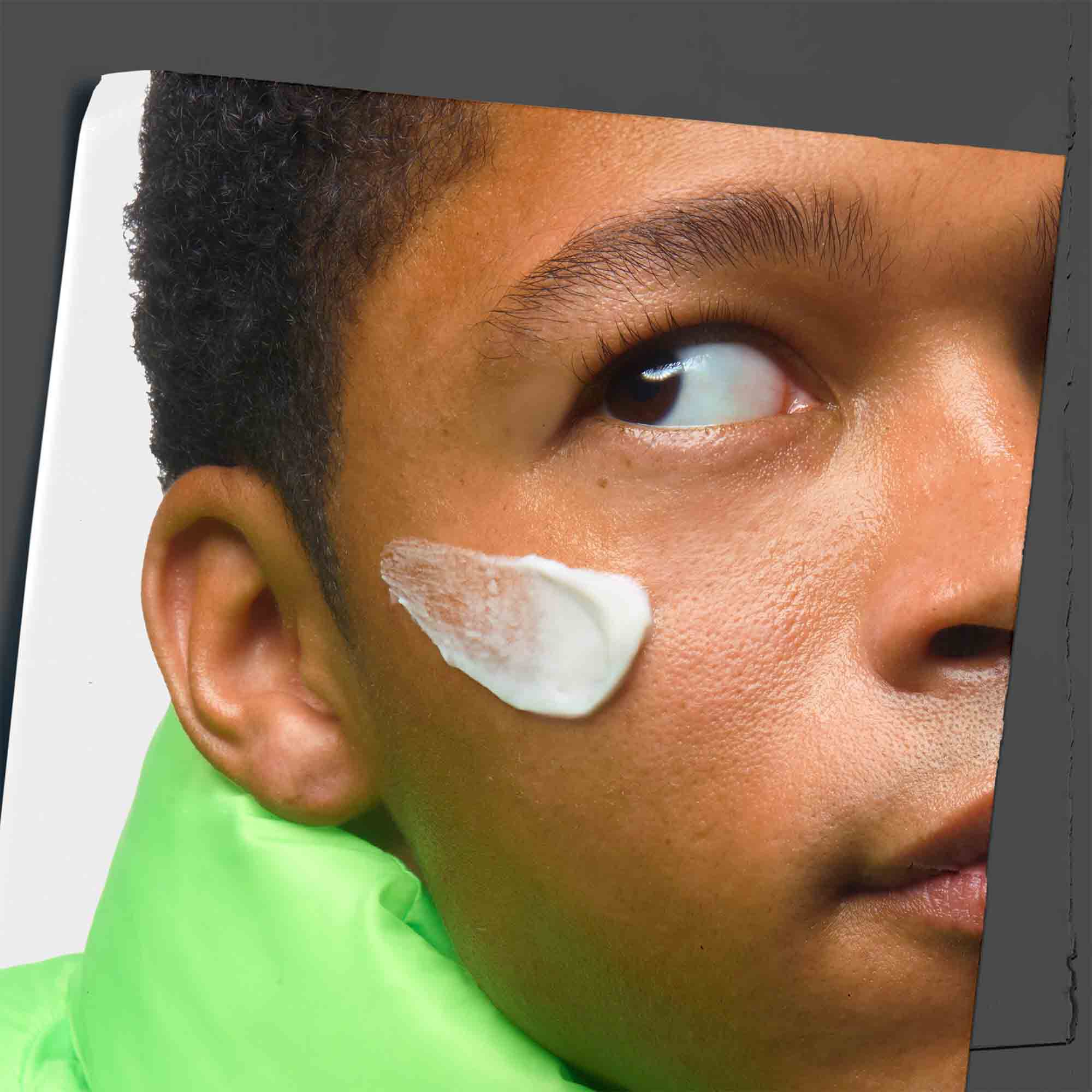 Age Defender Cream Moisturizer swiped on a model’s face.