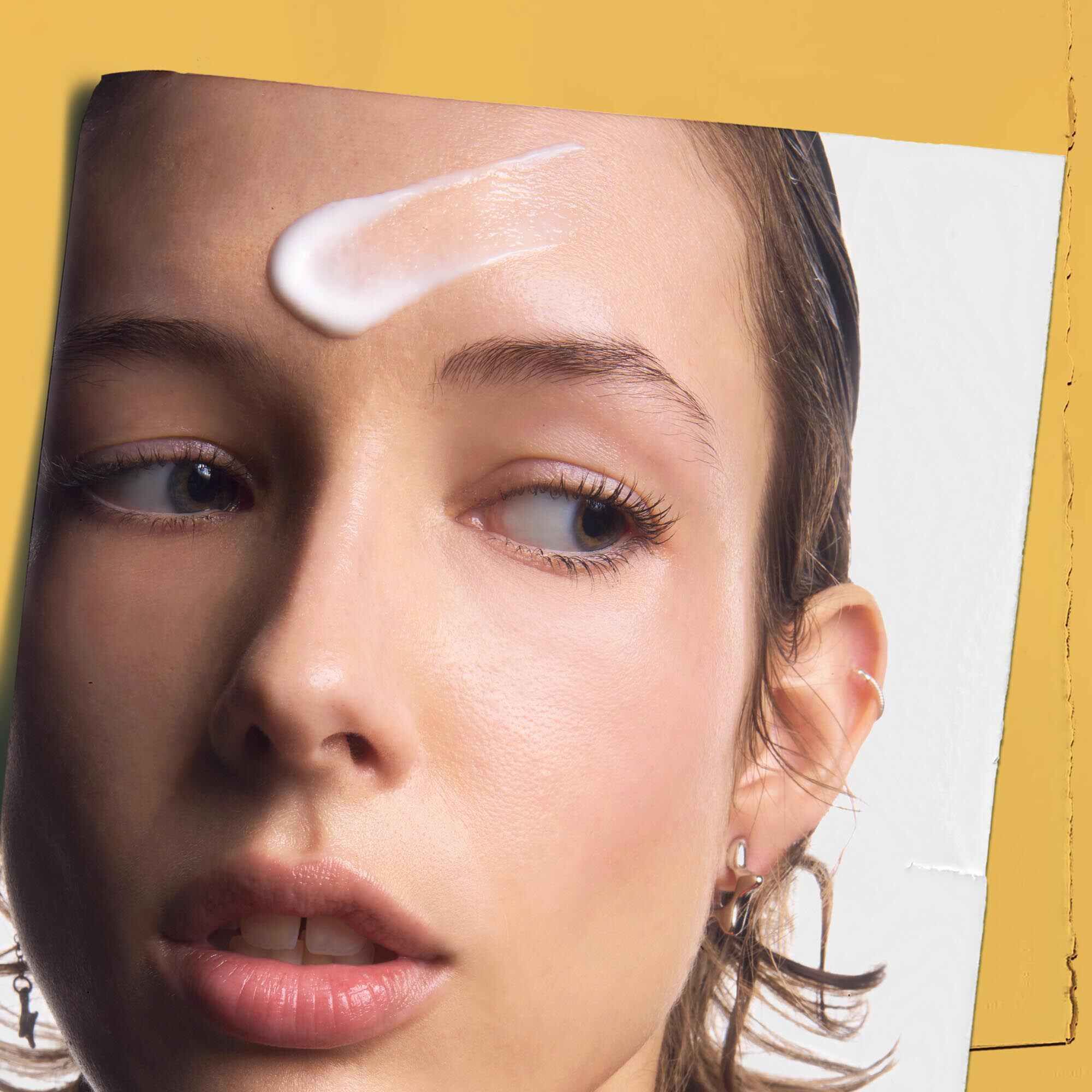 Powerful-Strength Line-Reducing Concentrate applied to a person's forehead, demonstrating its use.