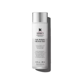 A graphic featuring a frosted bottle of Kiehl's Daily Refining Milk-Peel Toner with a silver cap and a label with black text. 