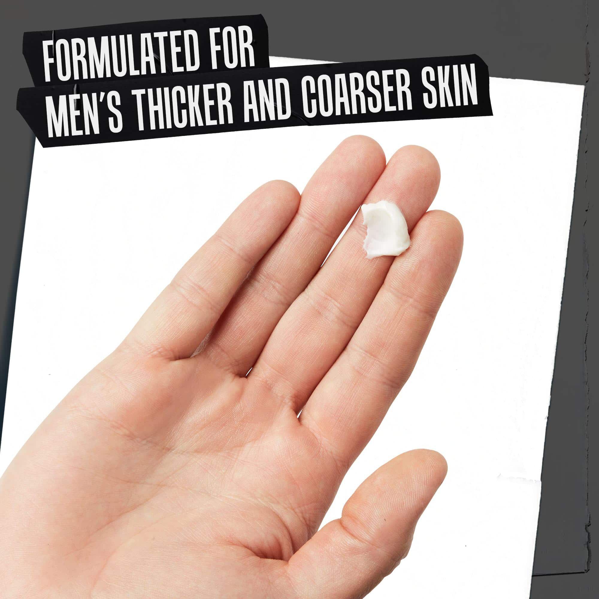 A hand holding Age Defender Cream Moisturizer; formulated for men’s thicker and coarser skin.