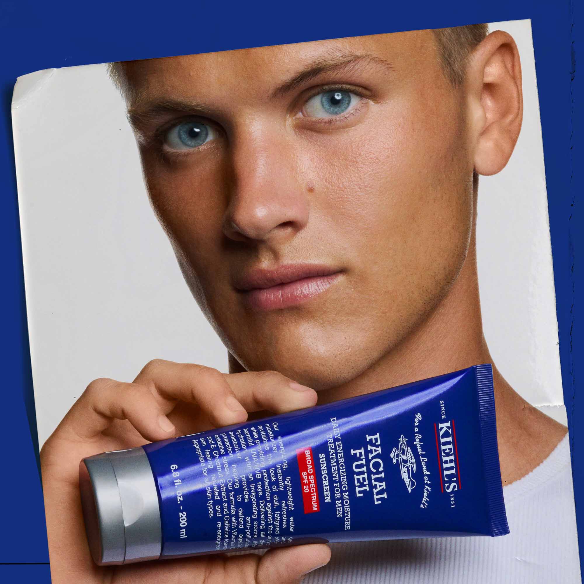 Facial Fuel Moisturizer SPF 19 being held, showcasing its use.