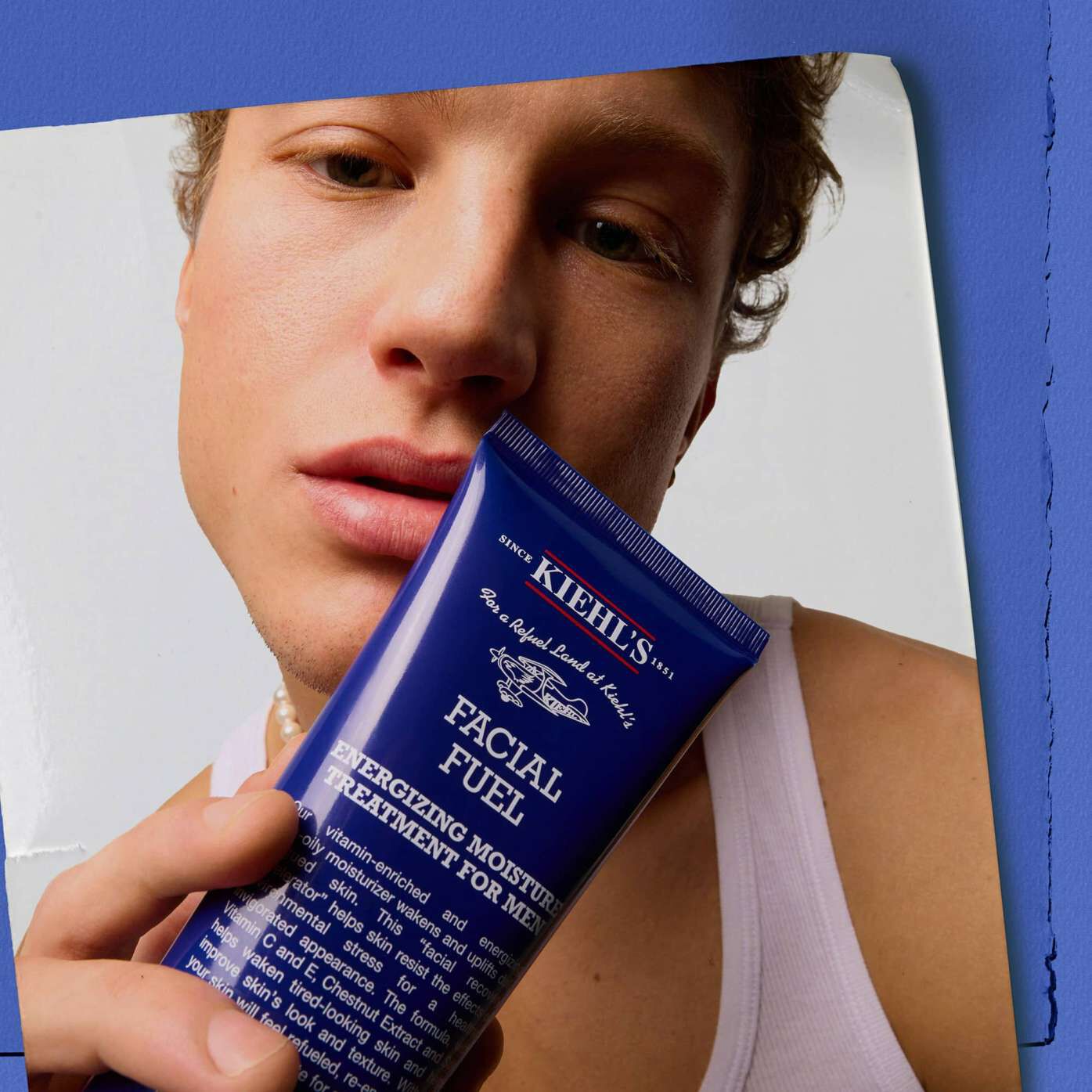 Model holding Kiehl's Facial Fuel Energizing Moisture Treatment for Men face moisturizer