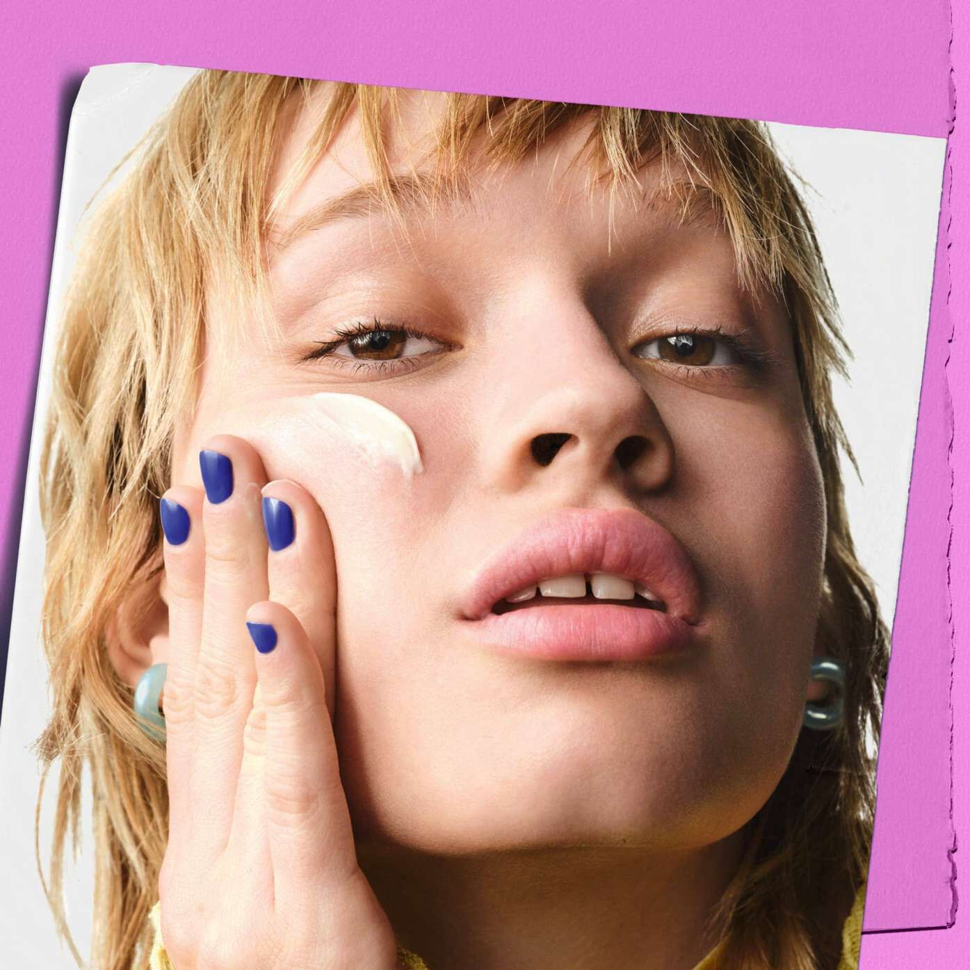 Model applying Kiehl's Super Multi-Corrective Cream to their cheek