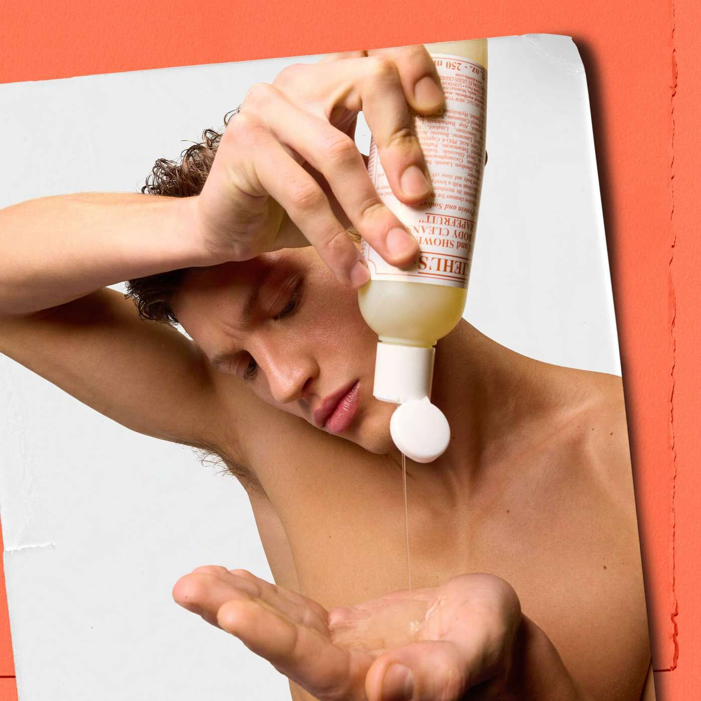 Model pouring Kiehl's Grapefruit Liquid Body Cleanser into their hand