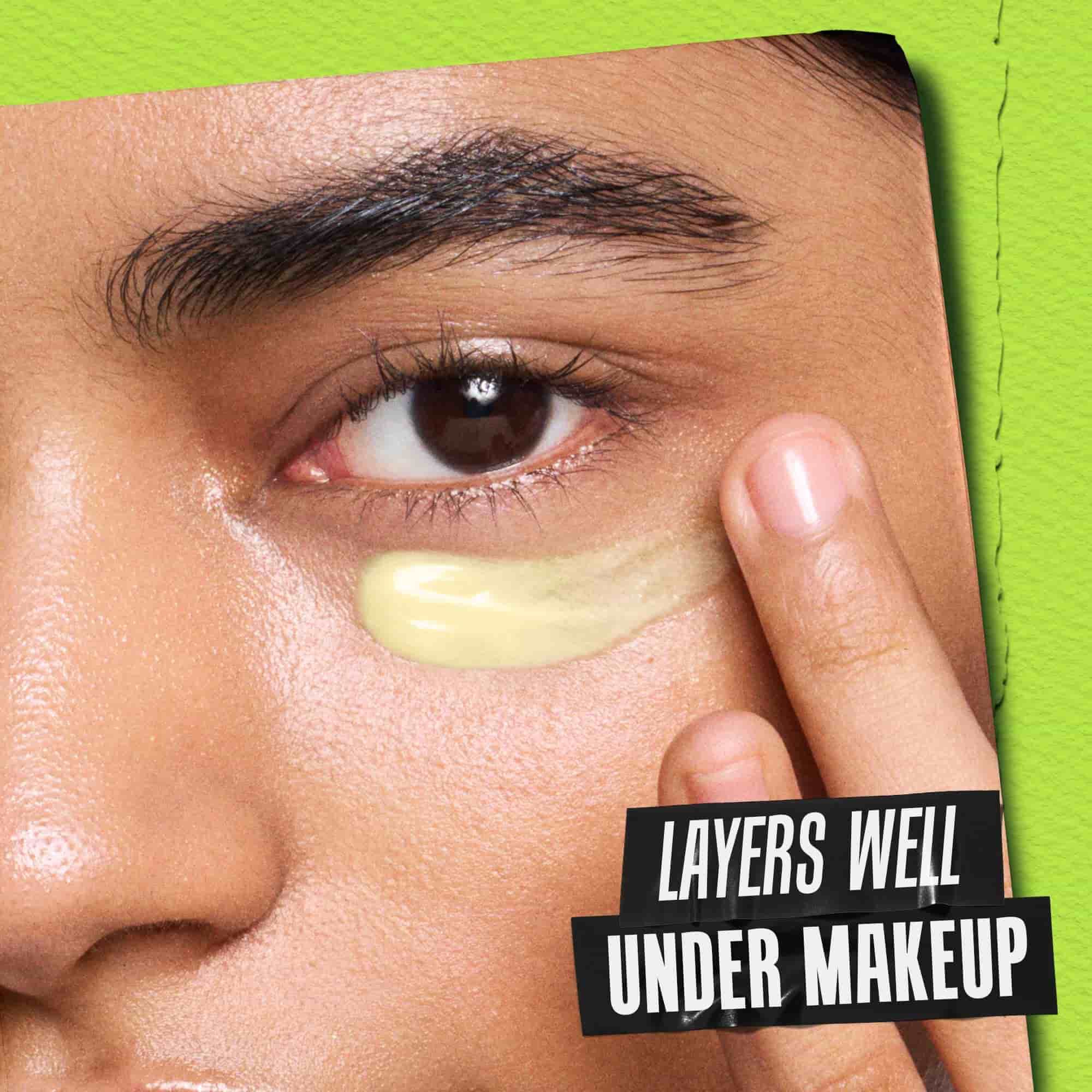 Winking model with a jar of Kiehl's Creamy Eye Treatment with Avocado covering one eye