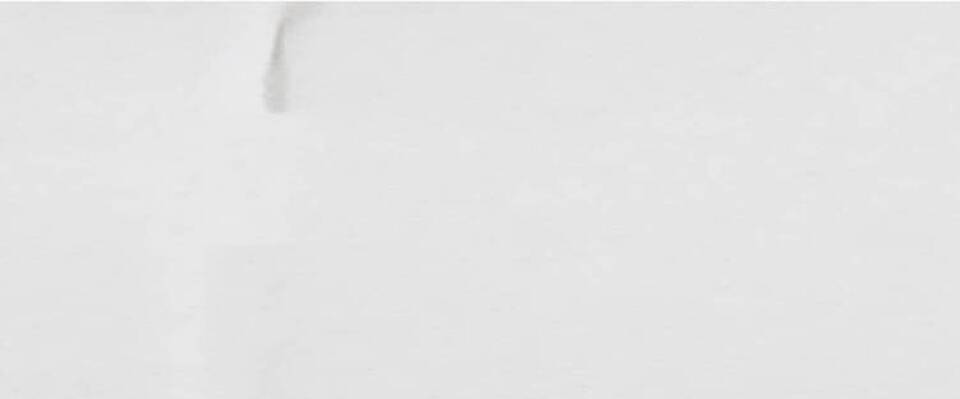 A minimalist image featuring a green leaf shape on a white background, with subtle textures and shadows.