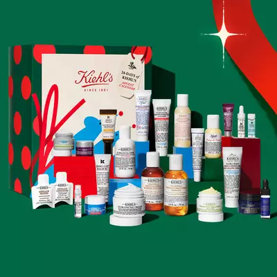 Kiehl’s holiday advent calendar and skincare gift set featuring assorted creams, serums, cleansers, and treatments on a festive display.