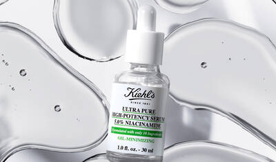 A bottle of Kiehl's Ultra Pure High-Potency Serum containing 5% niacinamide, displayed against a backdrop of translucent gel-like droplets.