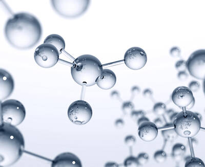 A close-up view of translucent, interconnected molecules with a light background, emphasizing their spherical shapes and fine details.