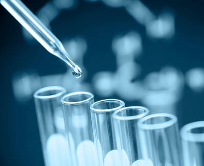 A close-up of a dropper releasing a liquid into a series of test tubes, set against a blue background with a molecular structure design.