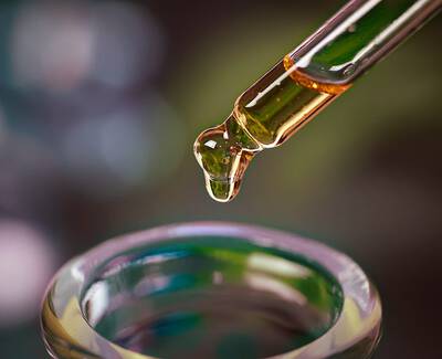 A close-up view of a variety of roasted coffee beans, showcasing different shapes and shades of brown.