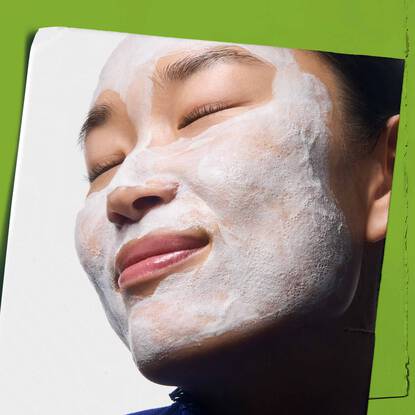 A young woman with a thick coat of Kiehl’s Rare Earth Deep Pore Daily as part of fake tan preparation.