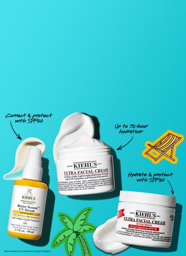 Flat lay of Kiehl's skincare products including UV serum, Ultra Facial Cream, and sunscreen jar with an orange popsicle on a purple-striped cloth background.