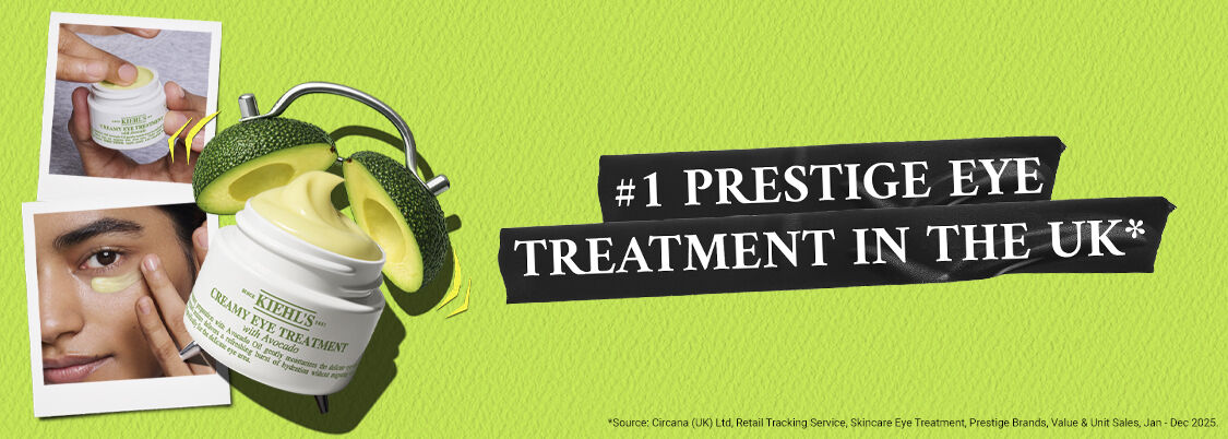 Jar of Kiehl's Creamy Eye Treatment with avocado slices and text "#1 Prestige Eye Cream in the UK" on a green background.
