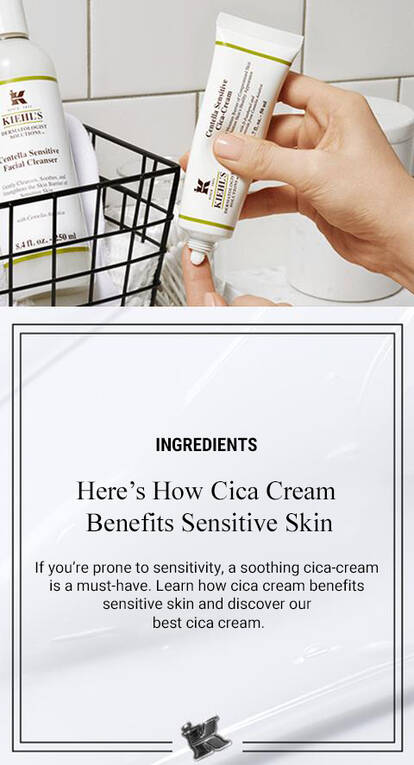 A clean bathroom setting featuring Kiehl's Cica Cream and a gentle facial cleanser. A hand holds the Cica Cream tube, and a wire basket displays the cleanser, emphasizing skincare for sensitive skin.