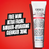 A white tube of facial cleanser stands against a vibrant red background. Bold black text to the left reads: FREE MINI ULTRA FACIAL BARRIER-HYDRATING CLEANSER 30ML
