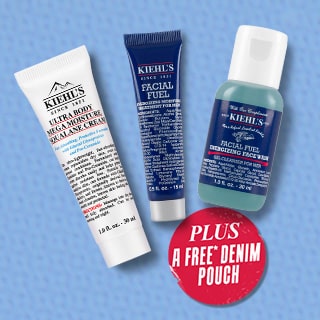 Three Kiehl's skincare products displayed on a blue background, including a cream and two cleansers, alongside a label for a free denim pouch.